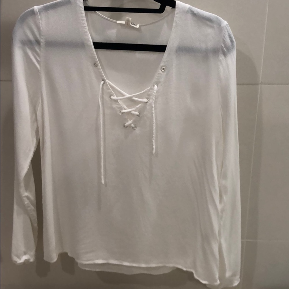 Long sleeve, small, white blouse. Ties in front.